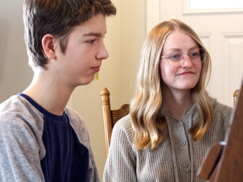 A student performing a piece on the piano