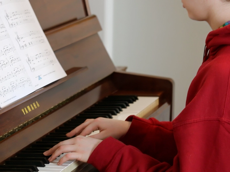 A student performing a piece on the piano
